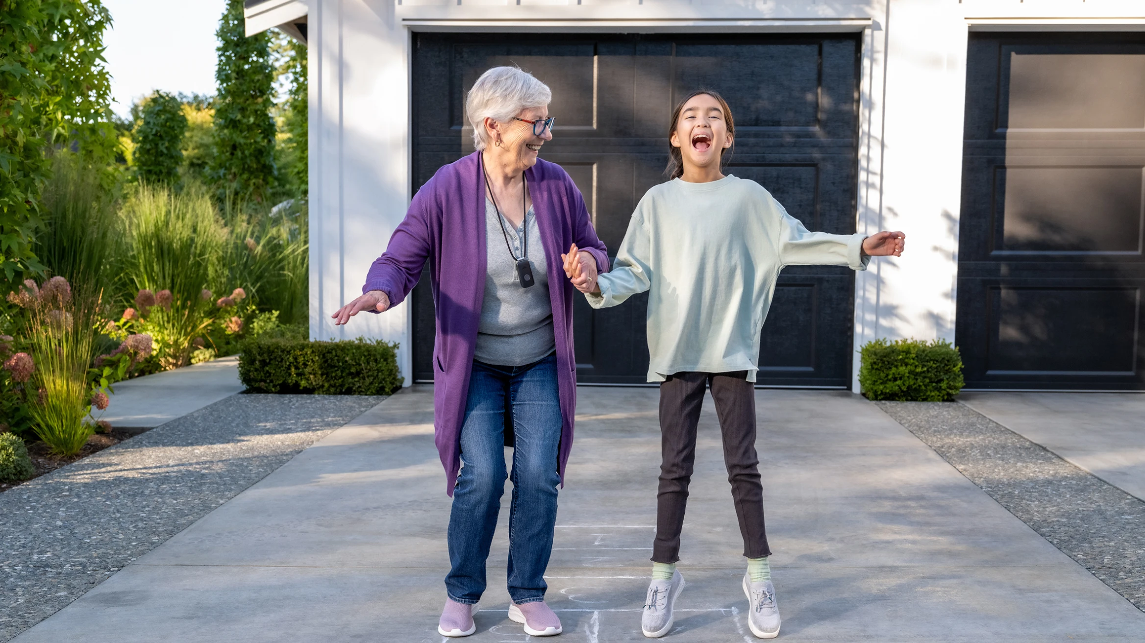 A caregiver and an older adult at home, in conversation.